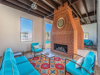 A living room with a fireplace and blue couches.